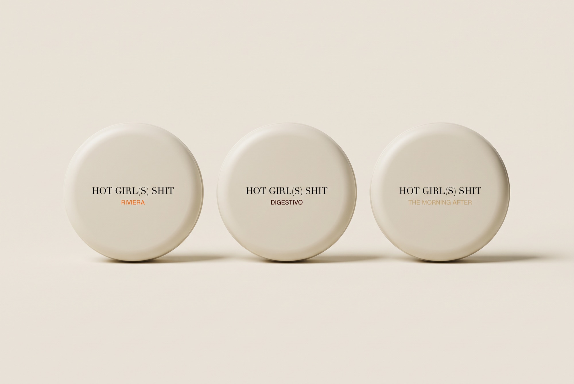 Three round dirty-cream tins: Riviera, Digestivo, The Morning After